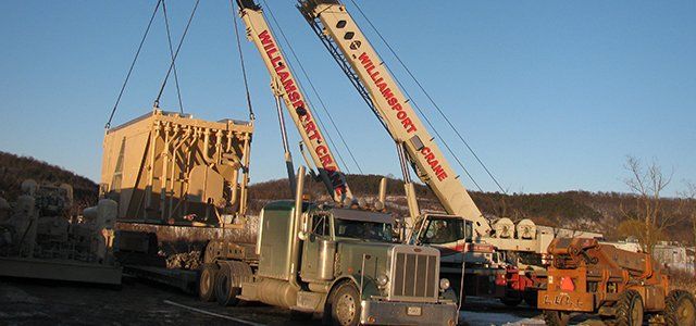 Cranes lifting heavy equipment