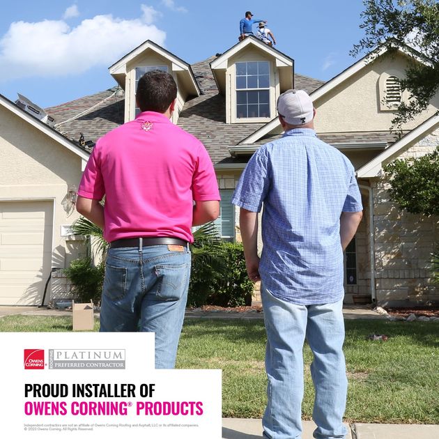 Two workers inspect a house roof; ad for Owens Corning roofing products in the corner.
