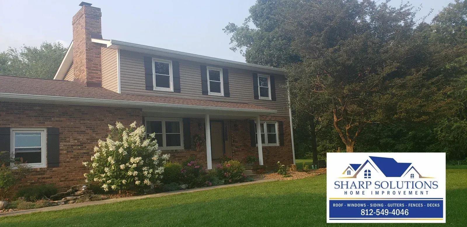 Brick two-story house with brown roof and white-trim windows; Sharp Solutions logo in lower right.