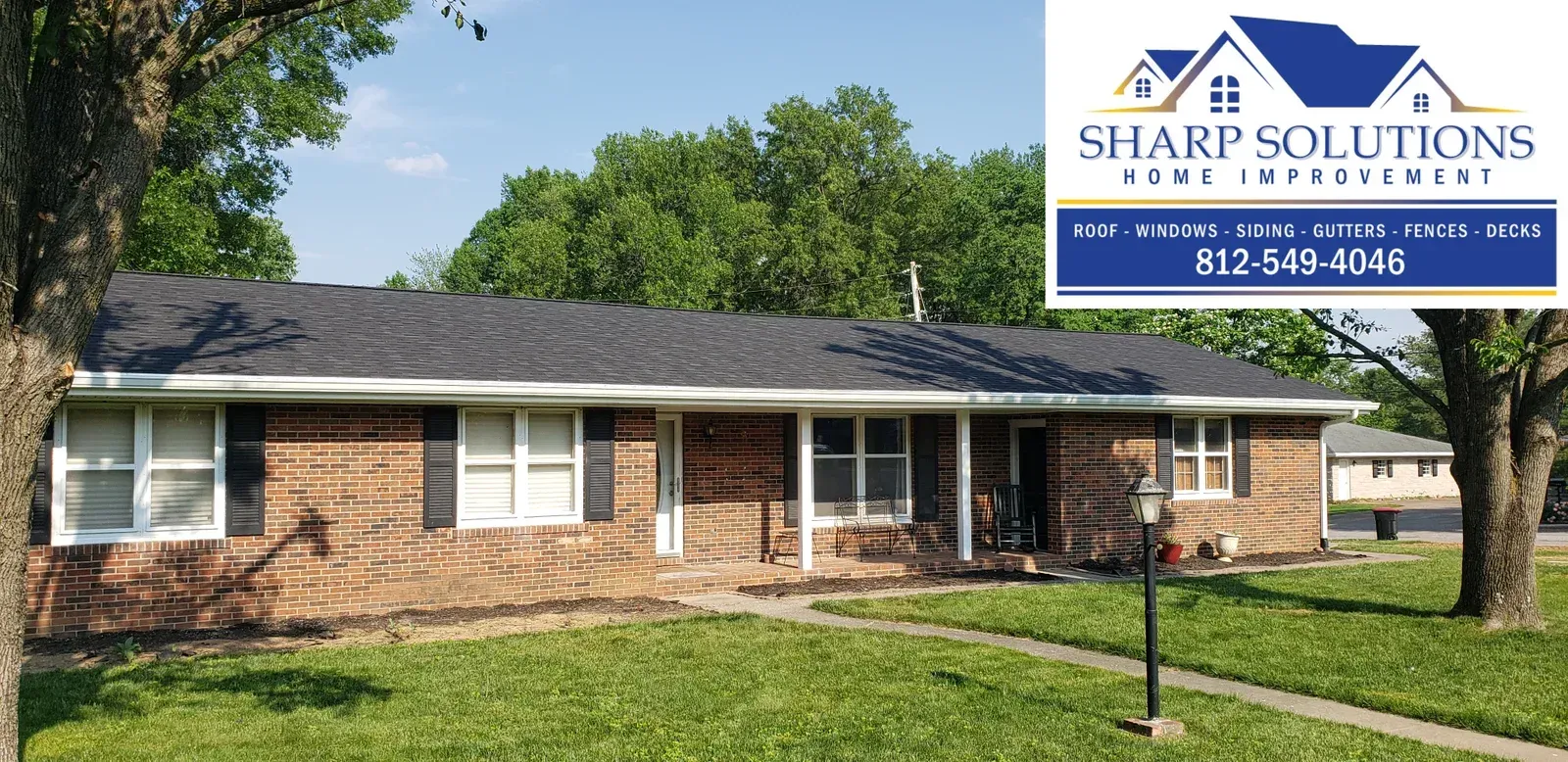 Single-story brick house with a lawn and a real estate sign in the yard.