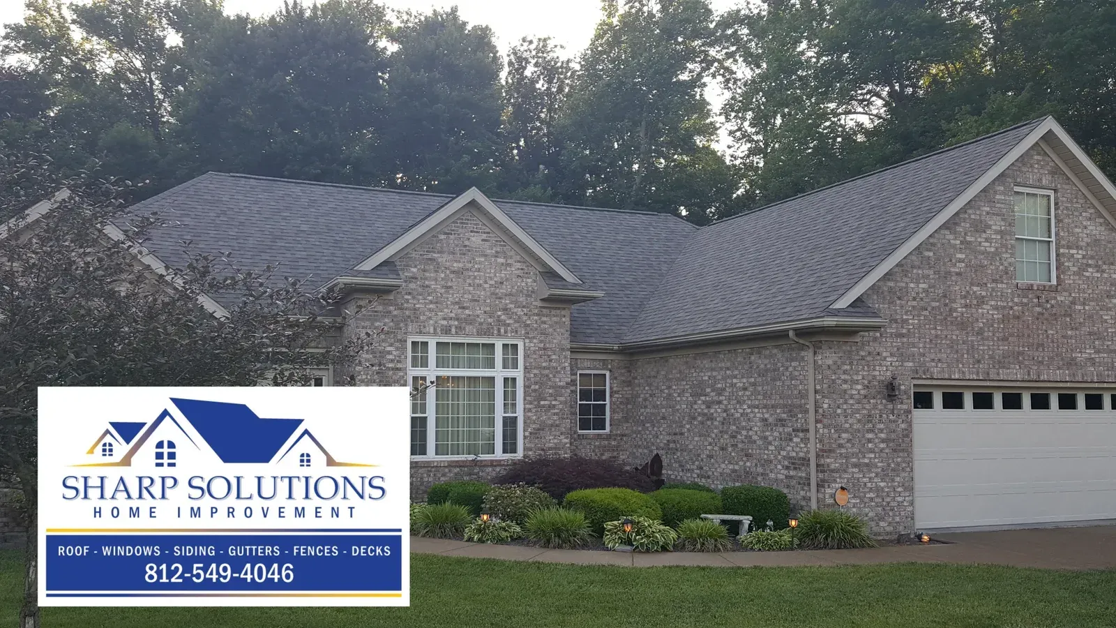 Brick house exterior with Sharp Solutions sign and phone number in the lower left.