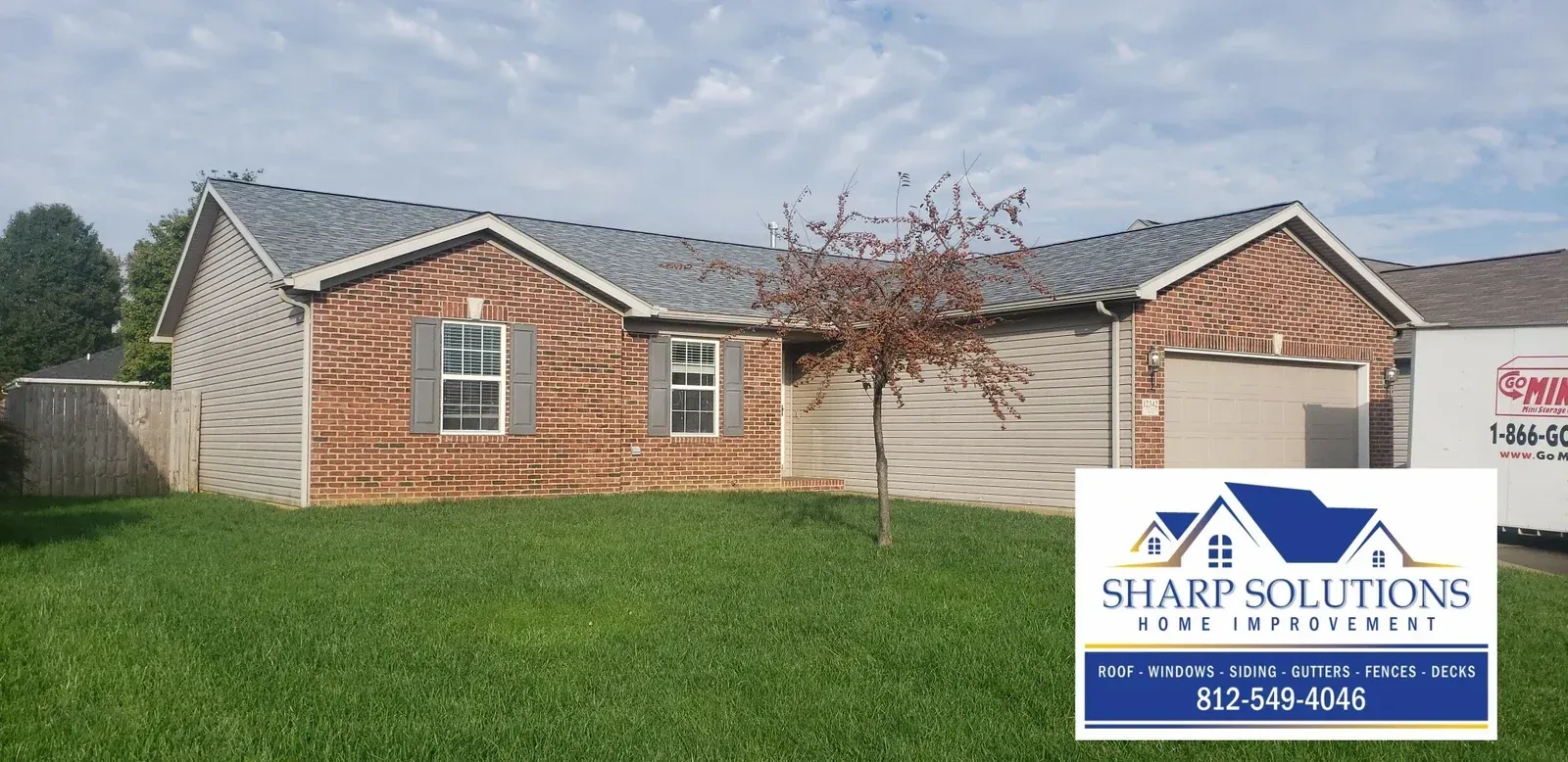 Brick single-story house with manicured lawn under a cloudy sky, Sharp Solutions logo in corner