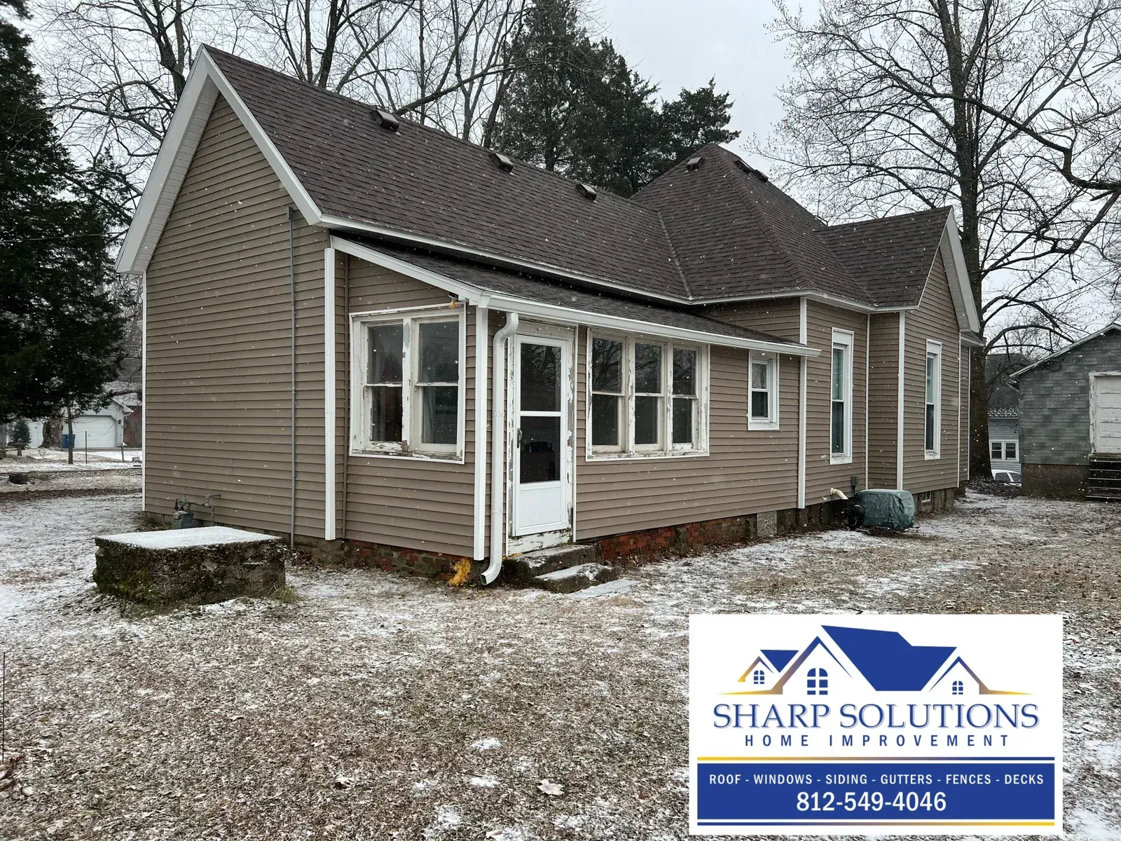 Snow-dusted tan house with white trim and a Sharp Solutions logo in the corner