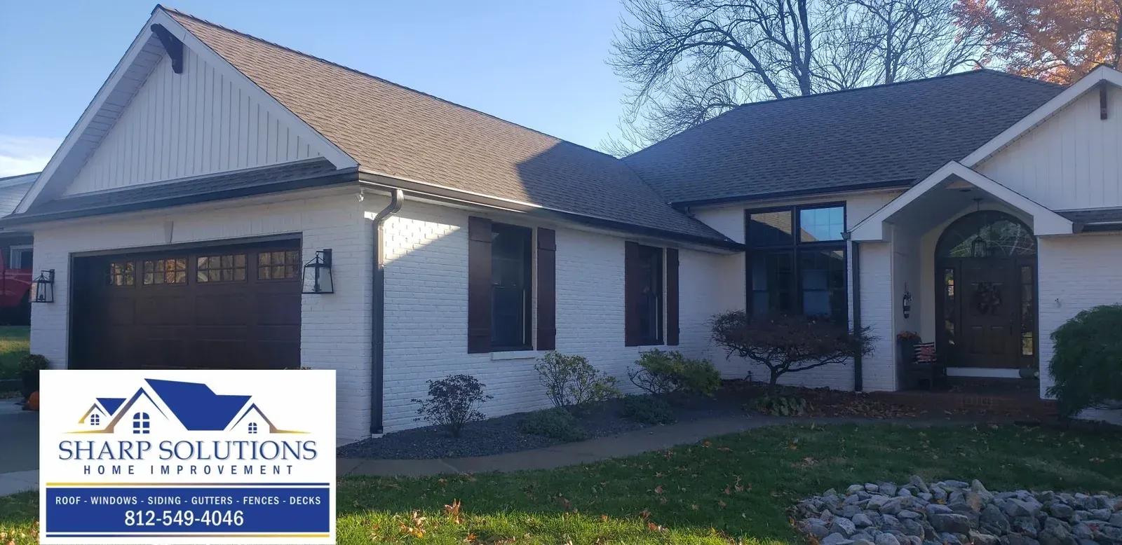 Exterior of a white single-story house with a two-car garage and tiled roof, for Sharp Solutions services