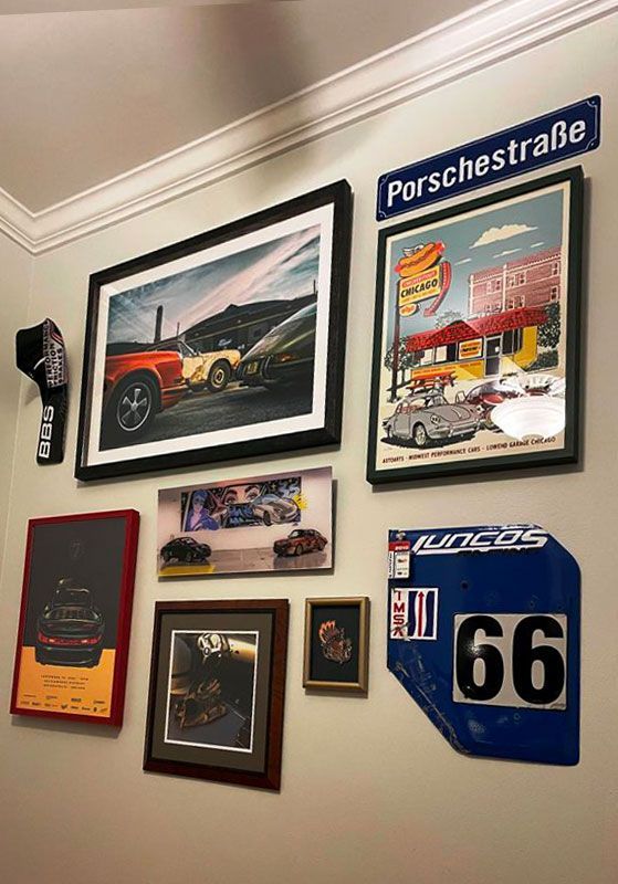 A wall with a lot of pictures and a sign that says 66 on it.