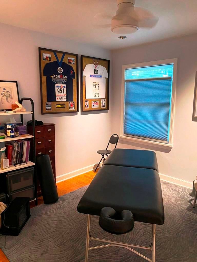 There is a massage table in the middle of the room.