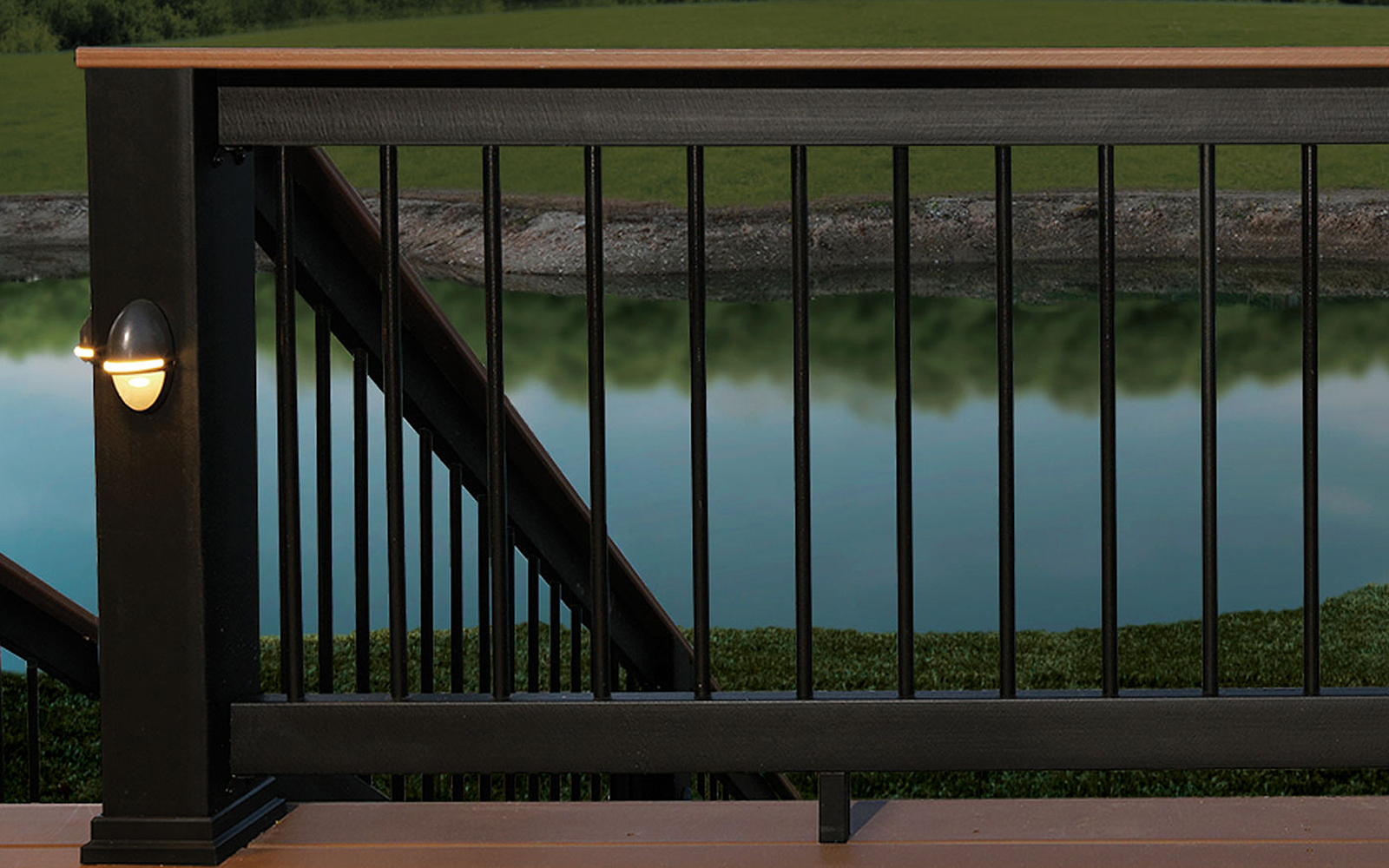A black railing on a deck overlooking a body of water.