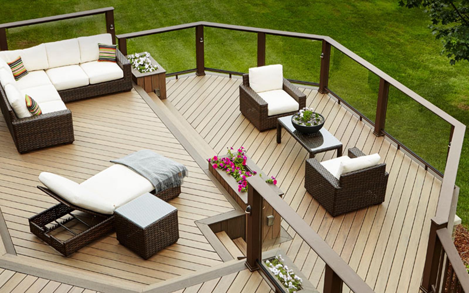 A deck with a couch and chairs on it