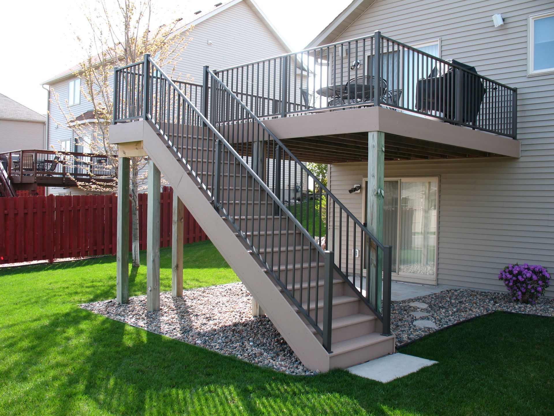 A house with a deck and stairs leading up to it