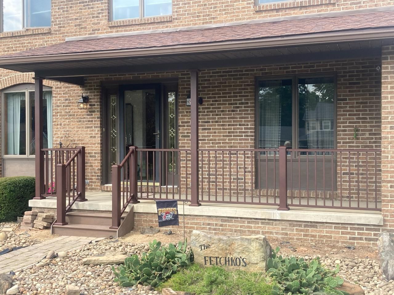A brick building with a porch and stairs