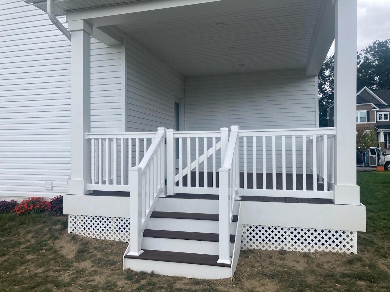 A white house with a porch and stairs