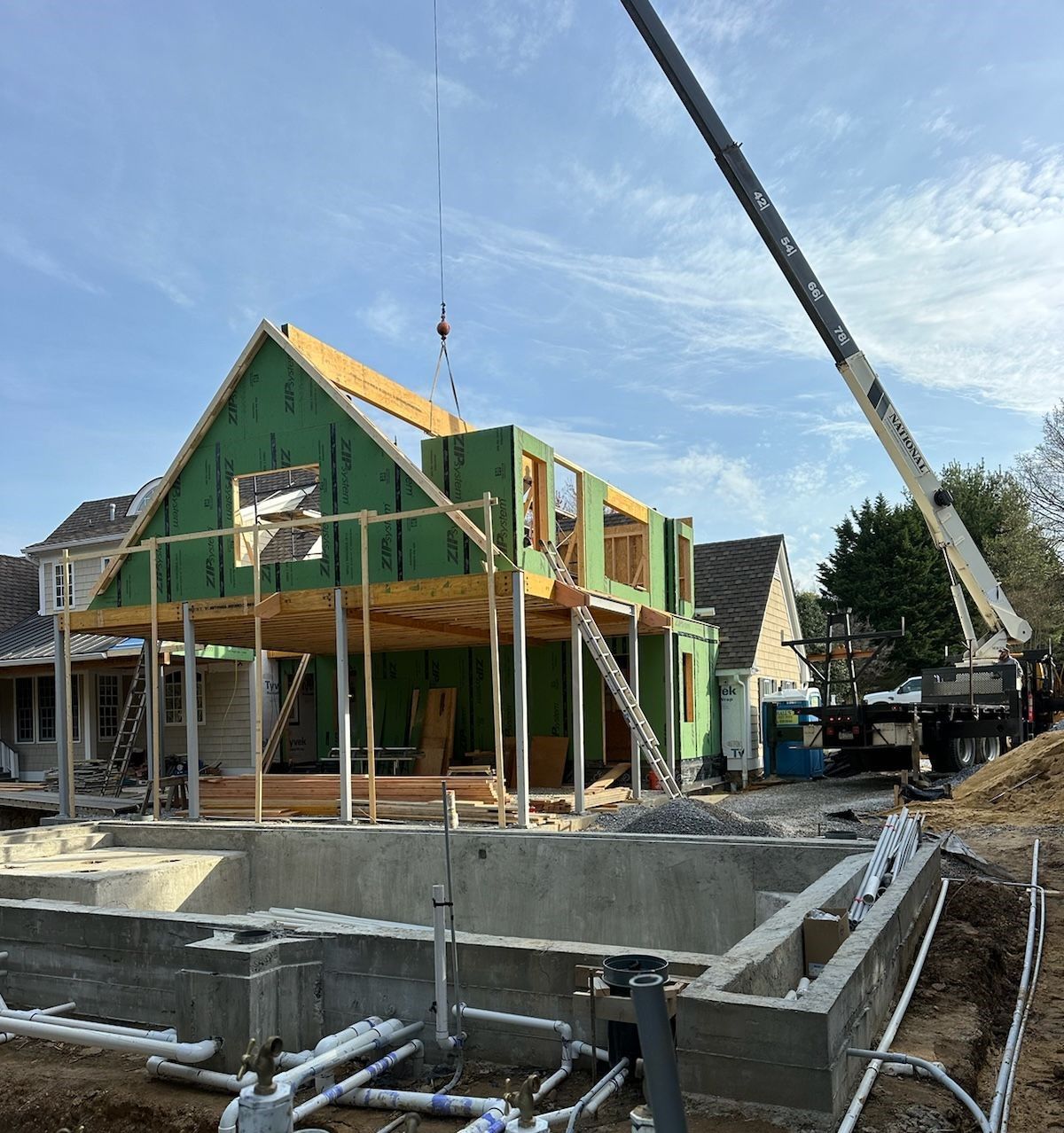 A house is being built with a crane in the background