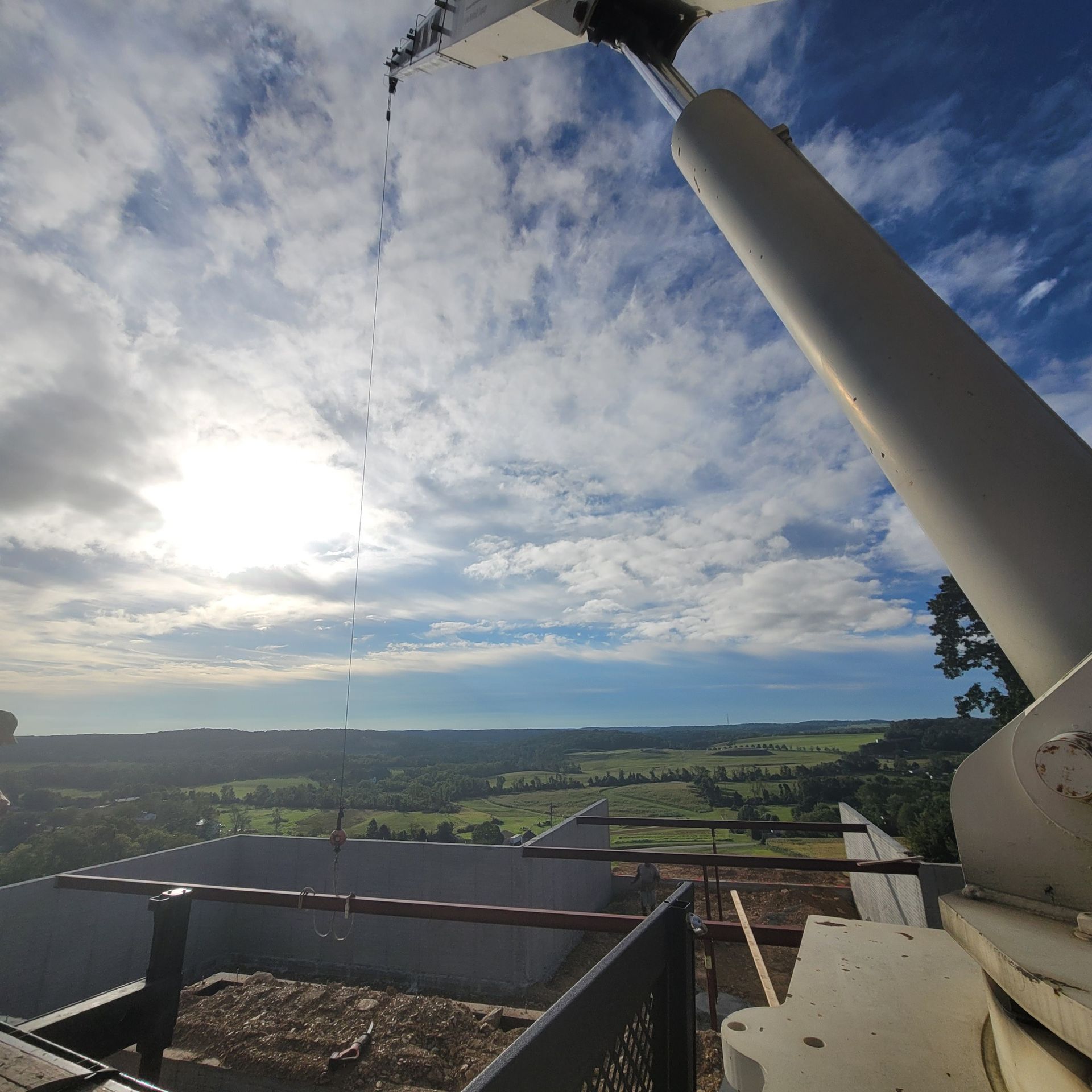 The sun is shining through the clouds in the sky