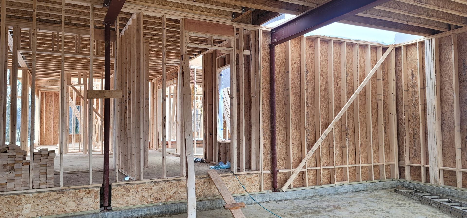 A house is being built with wooden beams and walls.