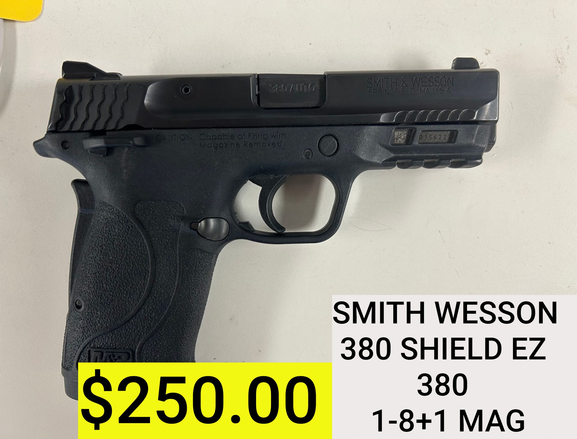 Black Smith & Wesson handgun with $250 price tag and model text on white background