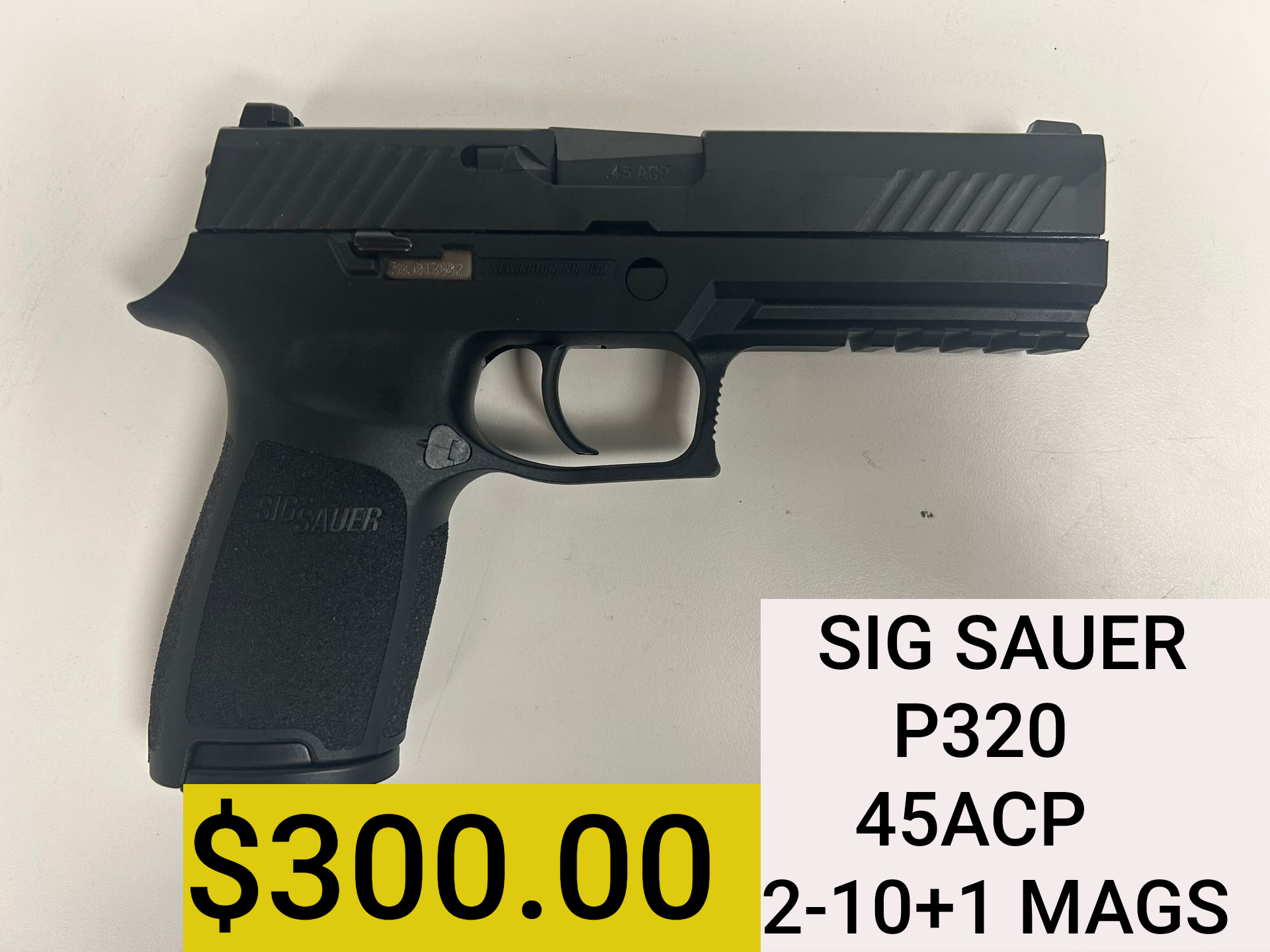 SIG Sauer P320 handgun on display with $300 price and “45ACP 2-10+1 MAGS” label