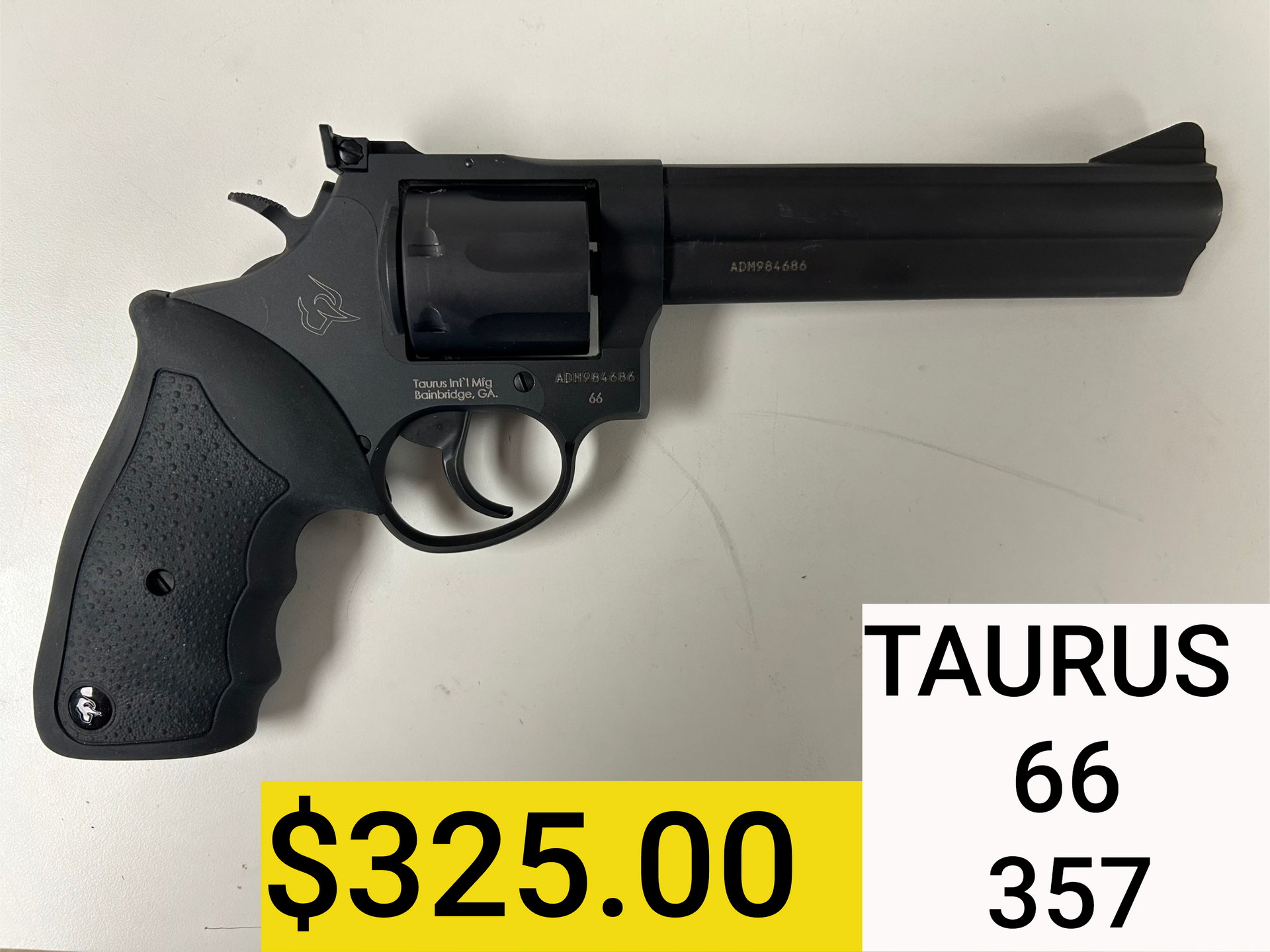 Black Taurus revolver with a long barrel, labeled $325, on a white background.