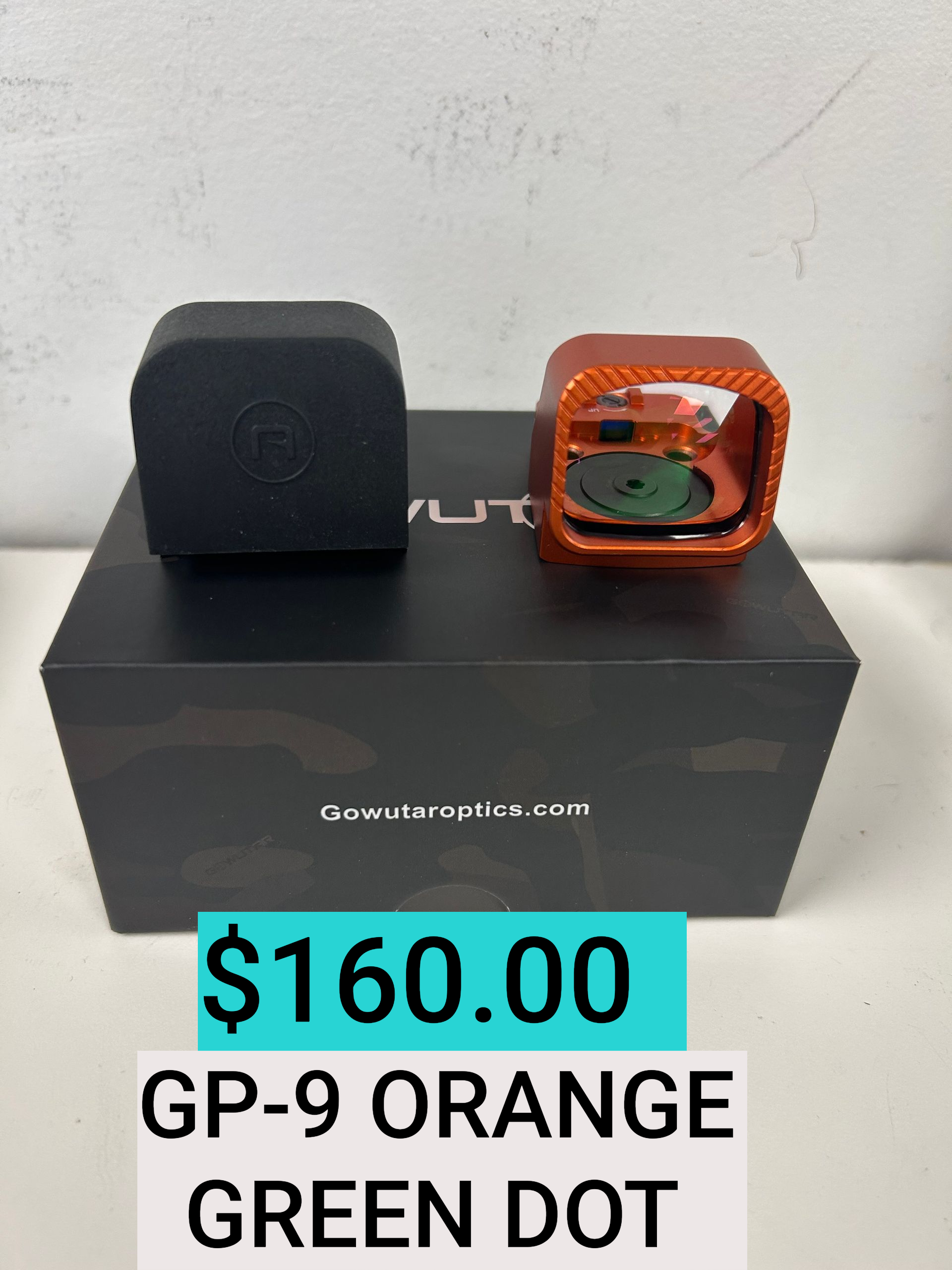 Orange GP-9 Green Dot watch with black case, displayed on a black box with $160 price tag.