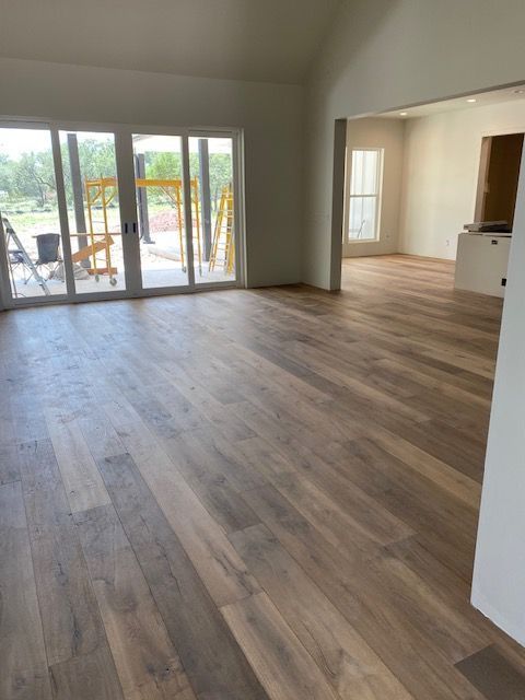 A living room with hardwood floors and sliding glass doors