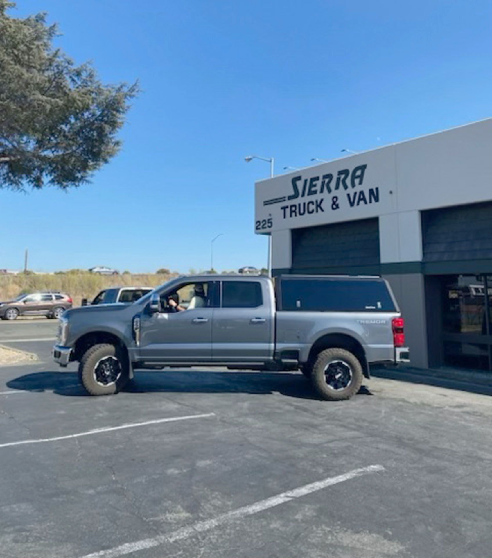 Silver pickup truck parked outside on a sunny day