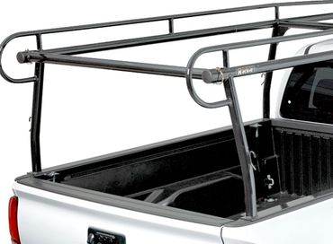 Silver ladder rack mounted on a white pickup truck bed