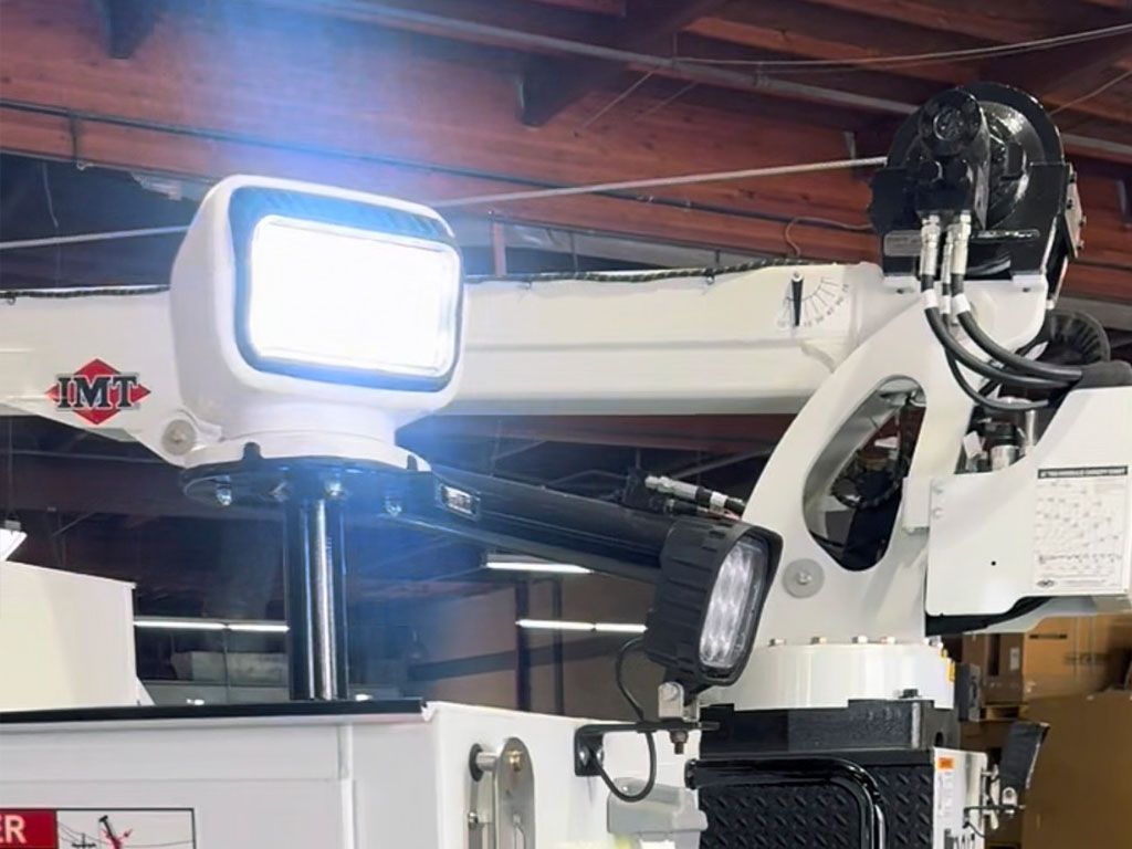 White boom lift with bright work light