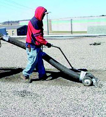 a man is using a vacuum cleaner to clean the ground 