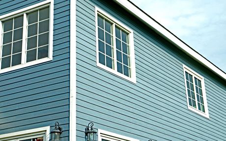 A blue house with white trim and a lot of windows