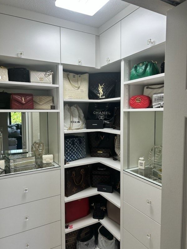A walk in closet filled with lots of handbags and jewelry.