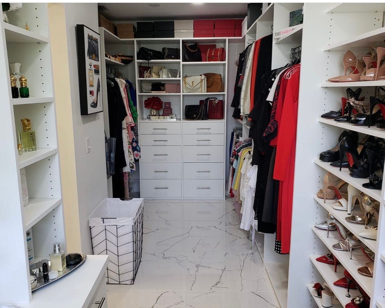 A walk in closet filled with lots of clothes and shoes