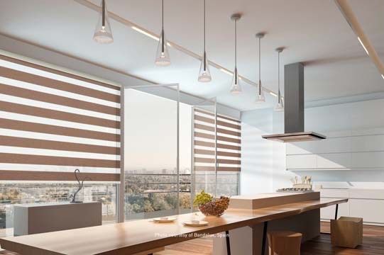 A kitchen with a long table and a stove top oven