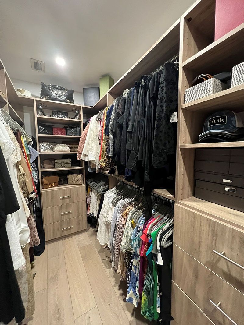 walk-in closet with clothes