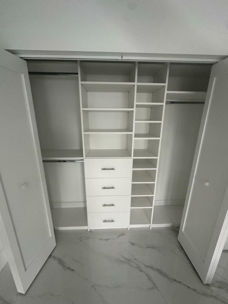 closet with lots of shelves and drawers