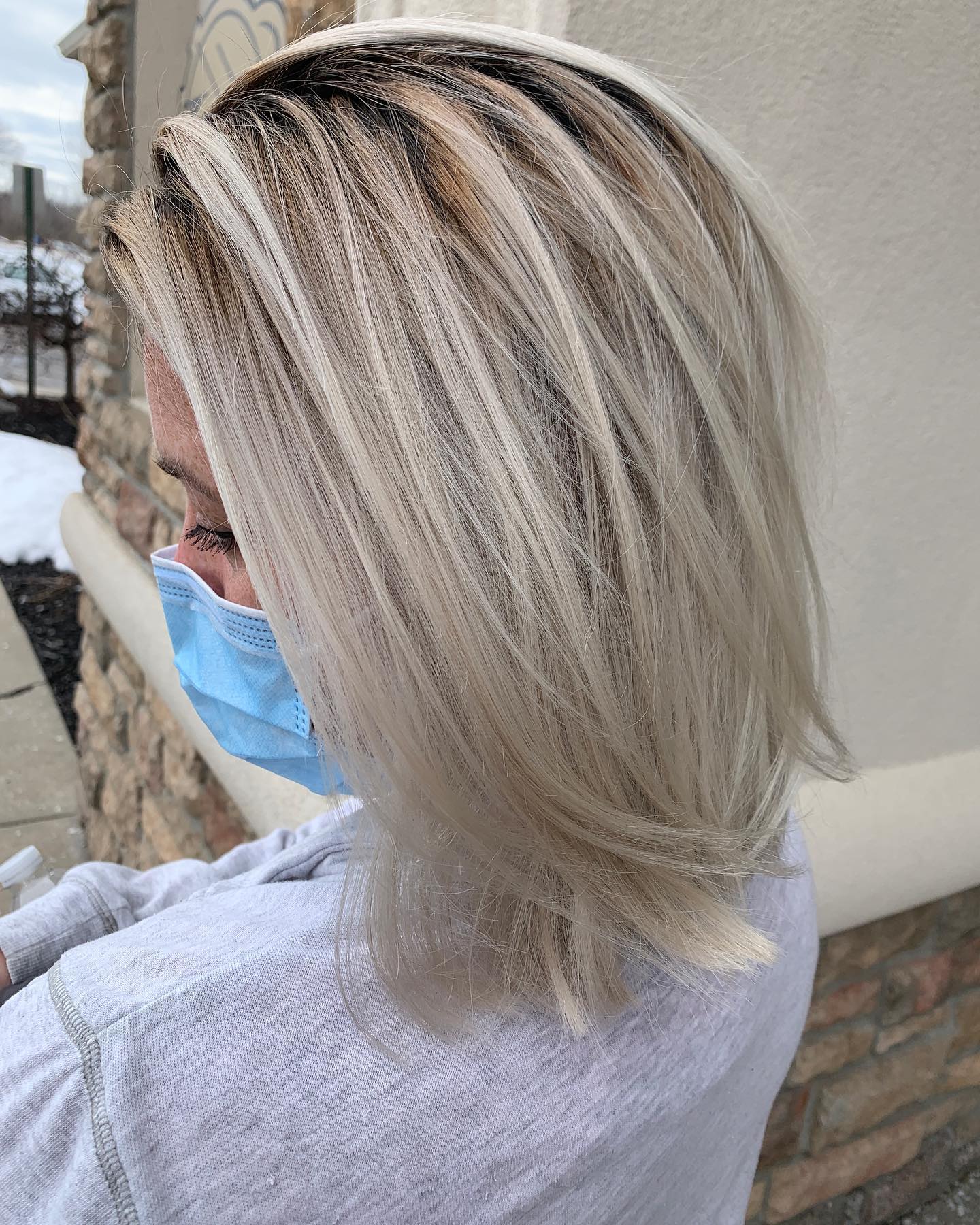 A woman with blonde hair is wearing a blue mask.