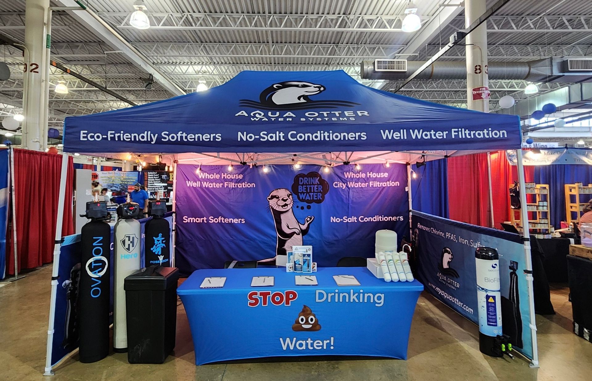 An Aqua Green booth at a trade show, advertising water softeners and filtration systems.