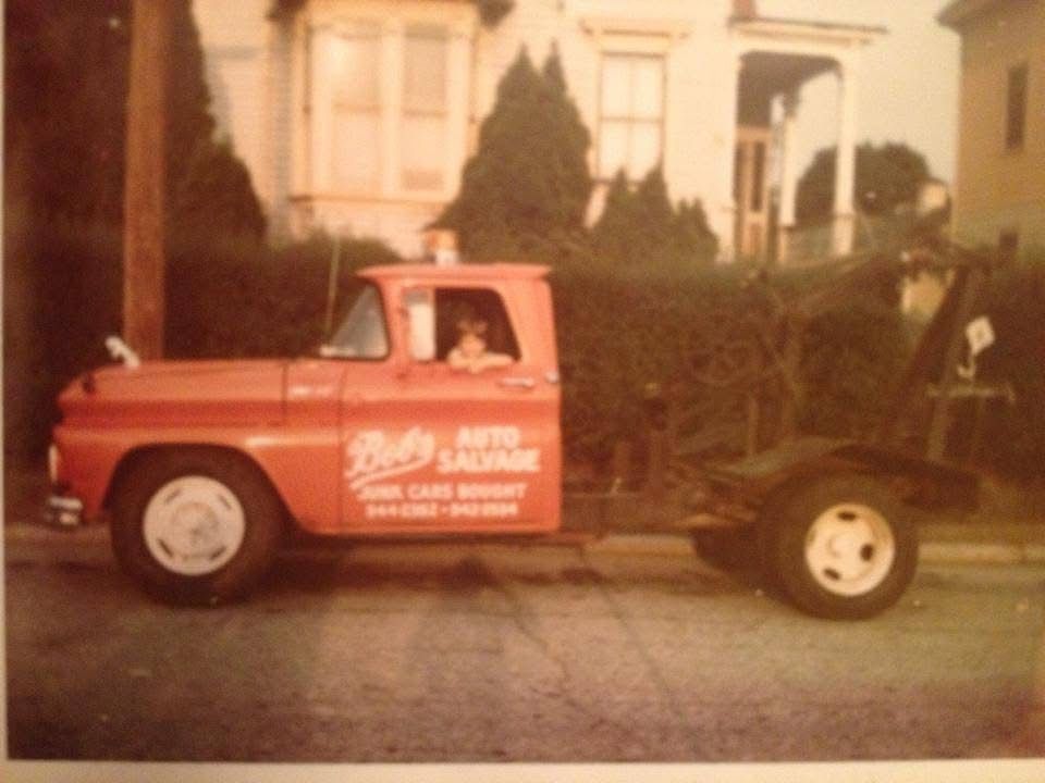 A red tow truck is parked in front of a house