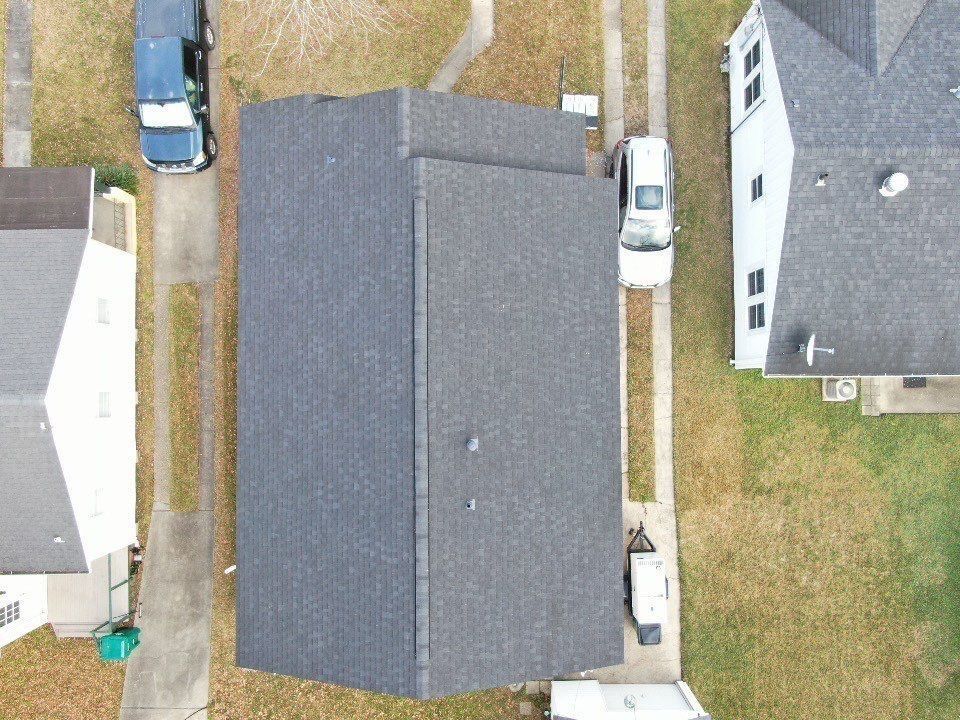 An aerial view of a house with a truck parked in front of it.