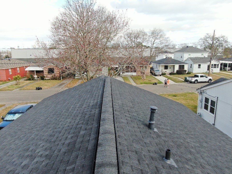 An aerial view of a roof of a house in a residential area.