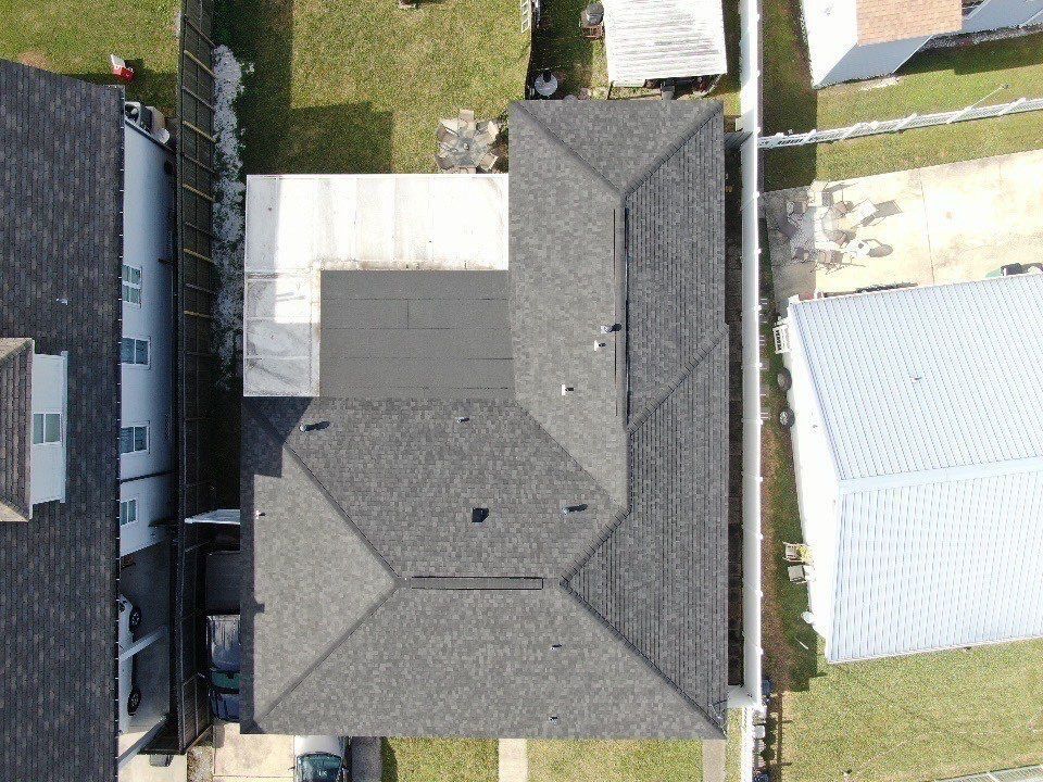 An aerial view of a house with a gray roof.