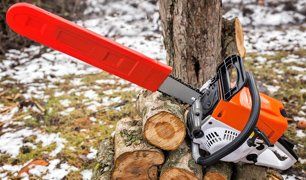 Chainsaw on pile of wood