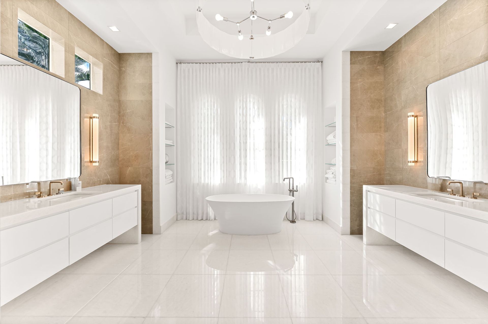 Luxurious white bathroom with double sinks, large tub, and light-colored walls, bright and airy.