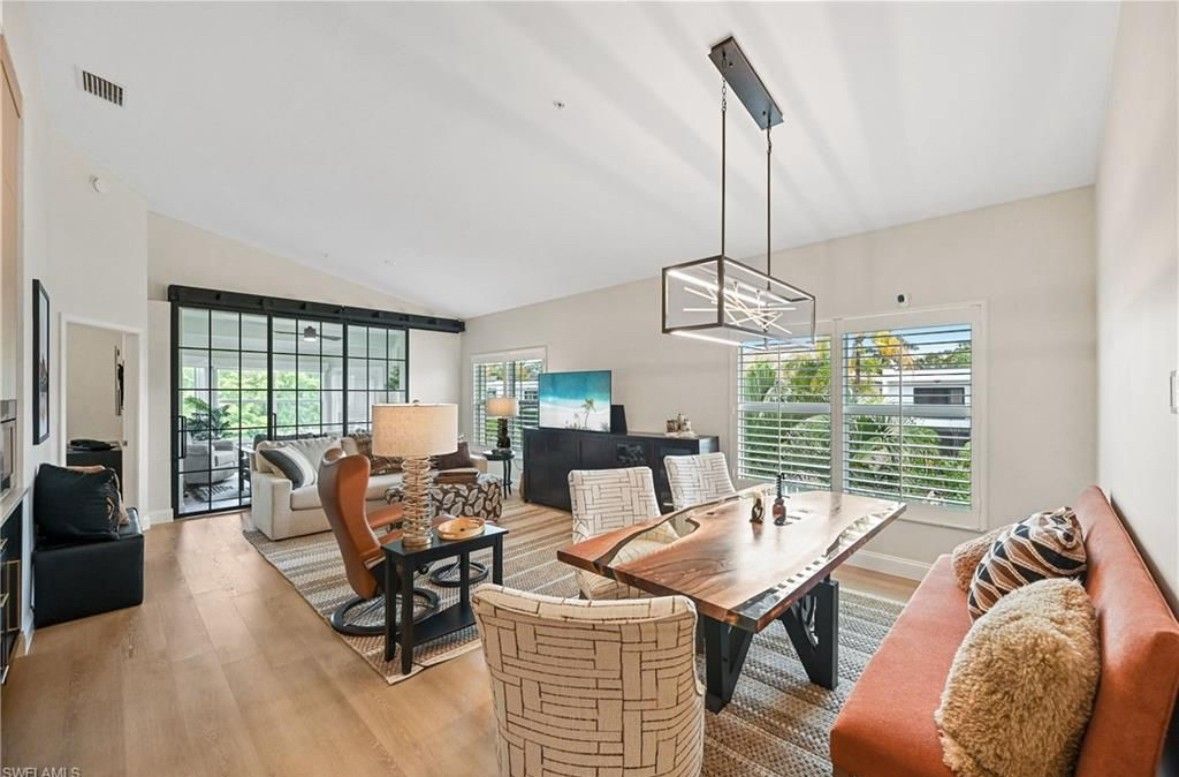 A living room with a couch , table and chairs.