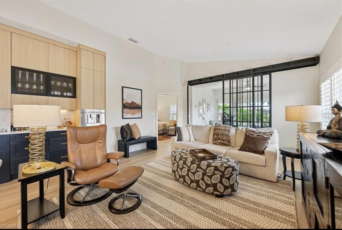 A living room with a couch , chair and ottoman