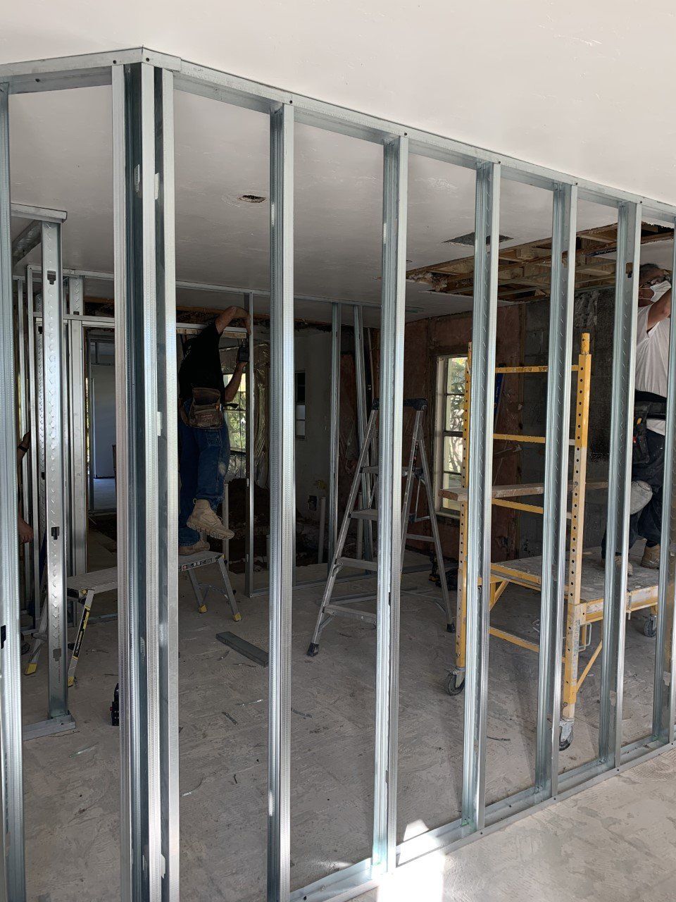 A room with a lot of metal walls and a ladder.