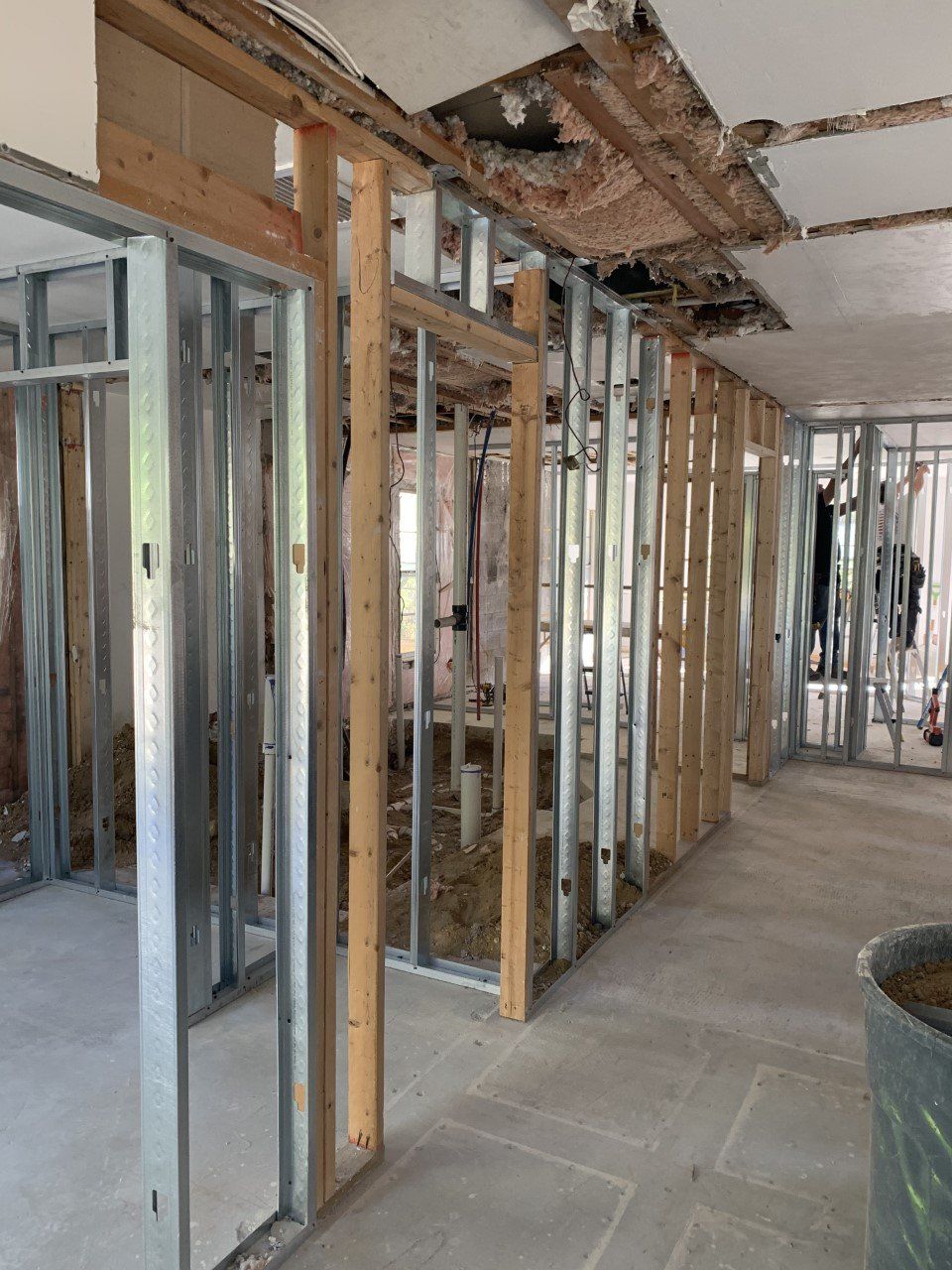 A building under construction with a lot of metal frames and wooden beams.