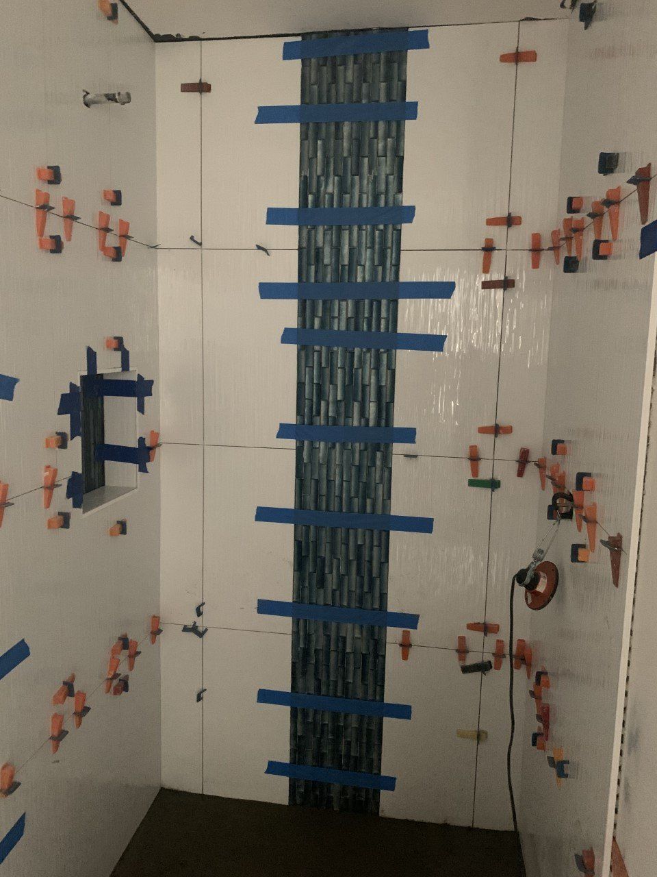 A room with a ladder made out of blue tape