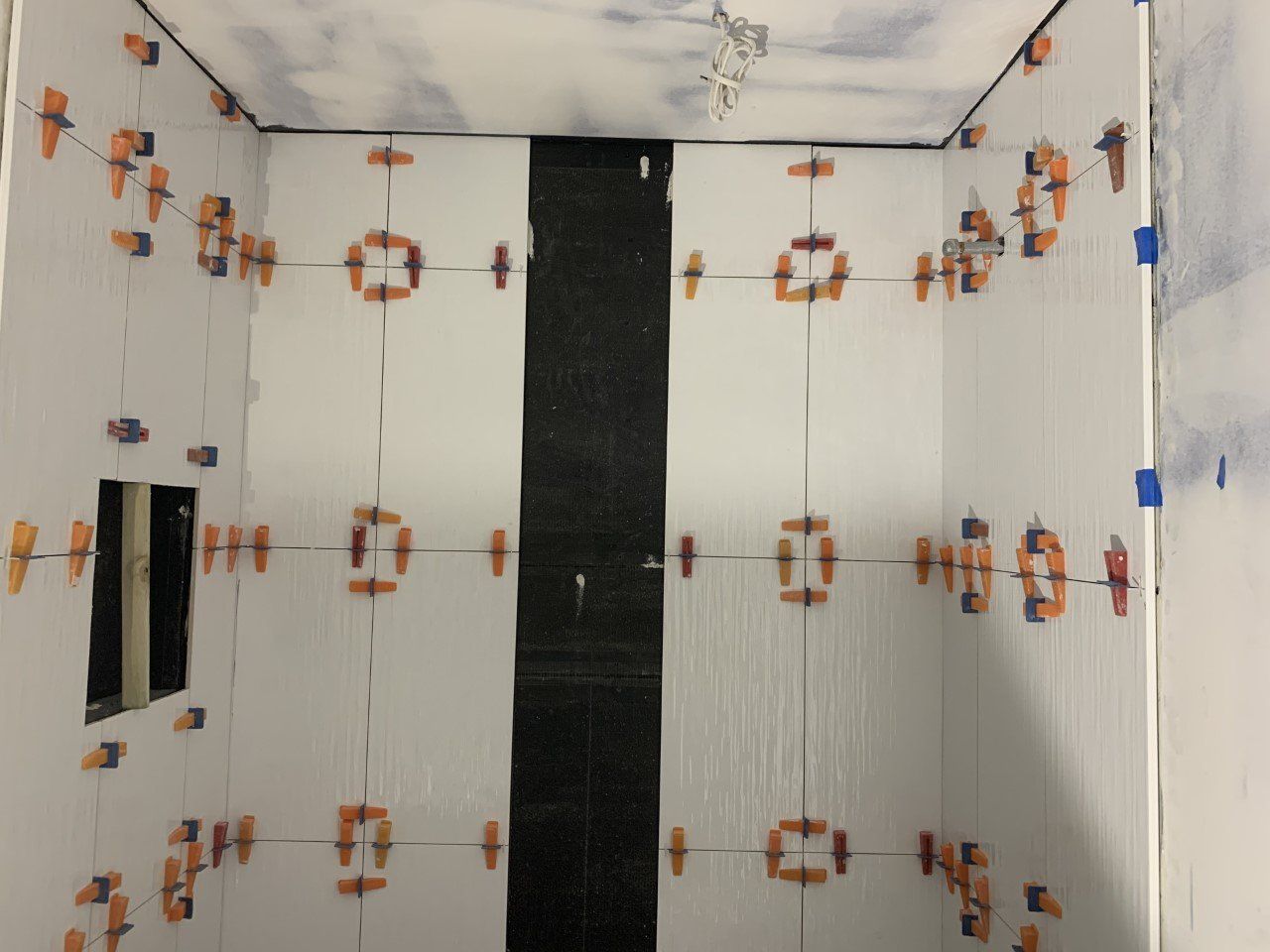 A room with a lot of tiles on the walls and ceiling.