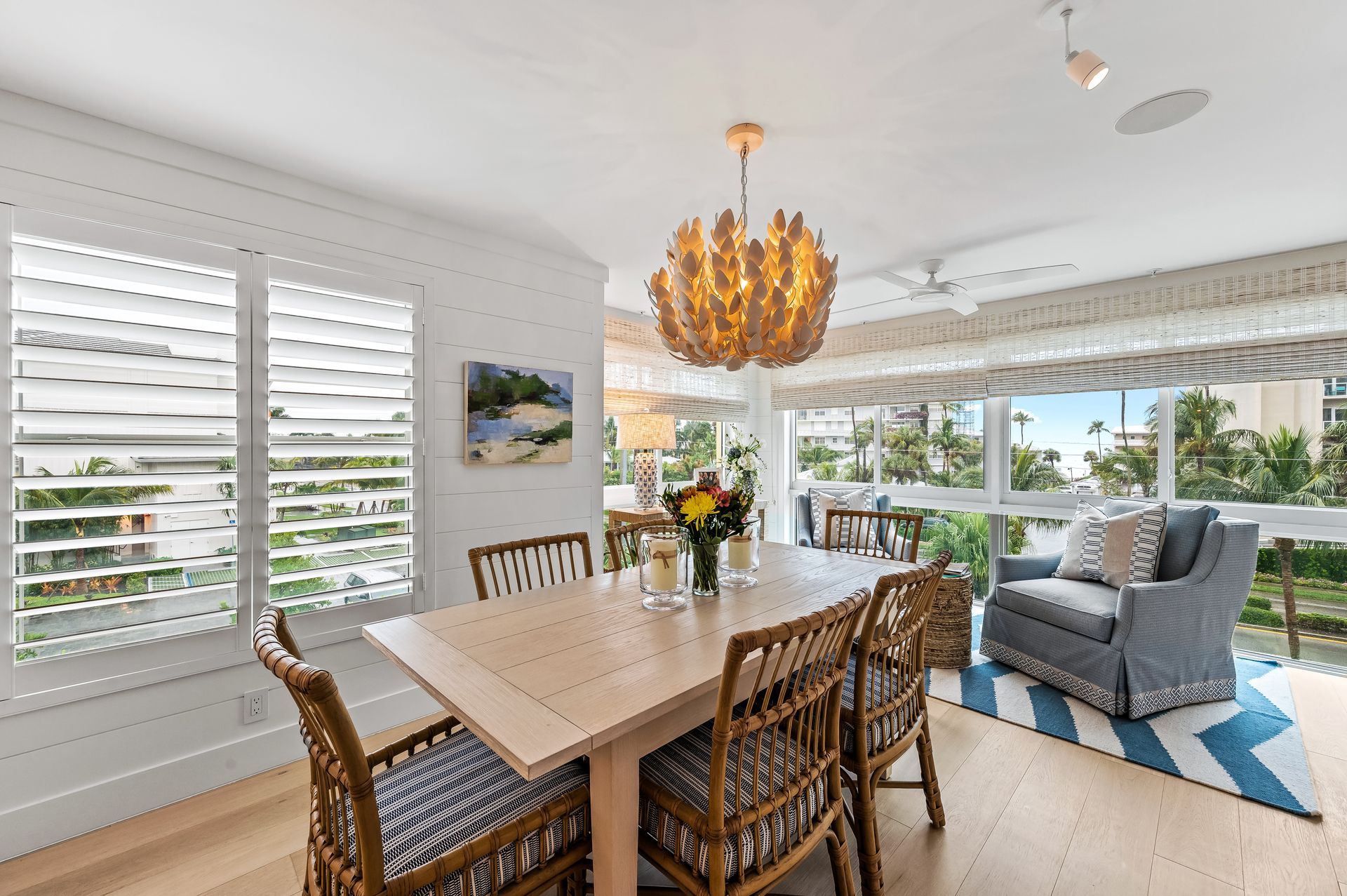 A dining room with a table and chairs and a chandelier.