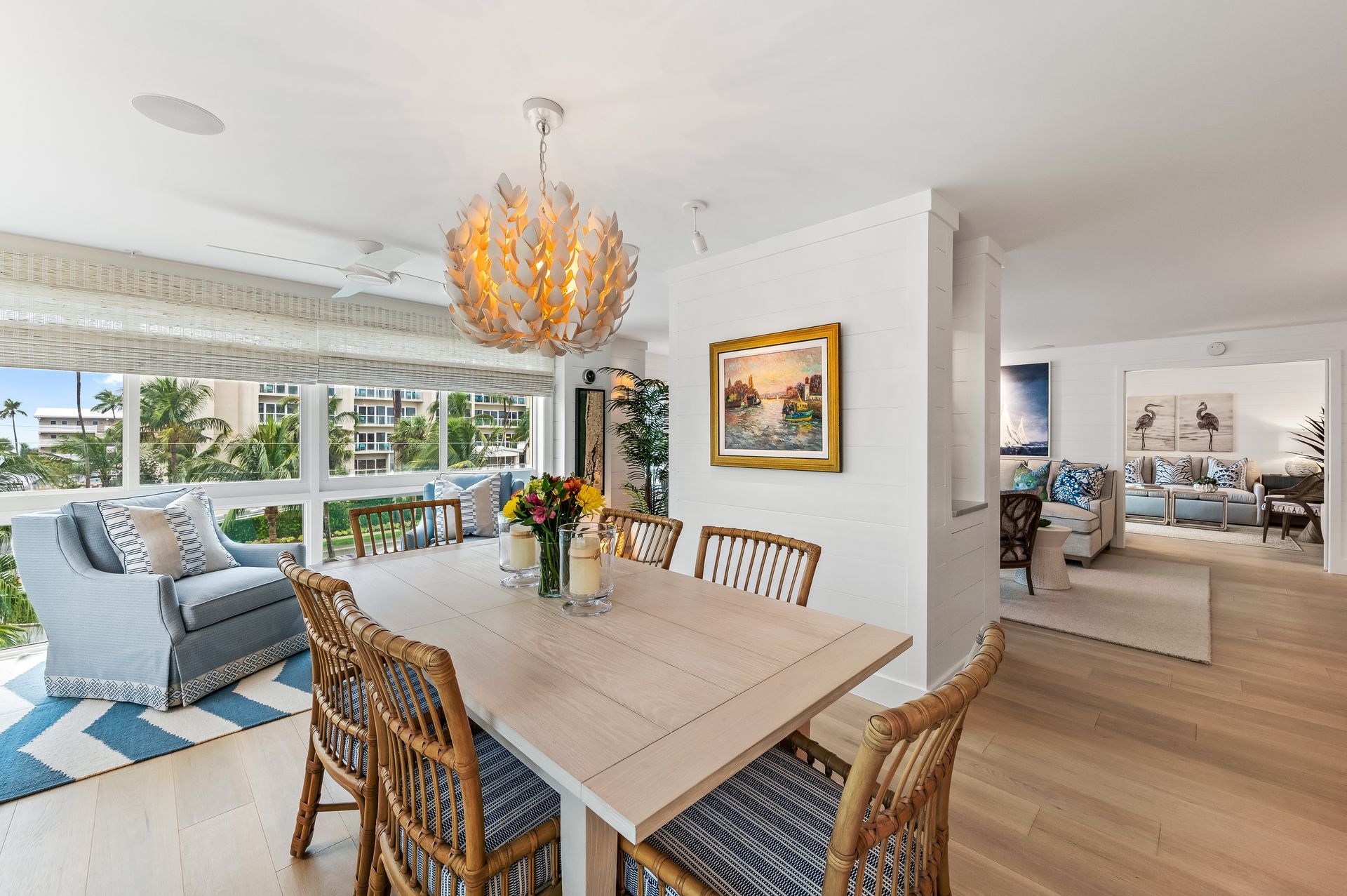 A dining room with a table and chairs and a chandelier.