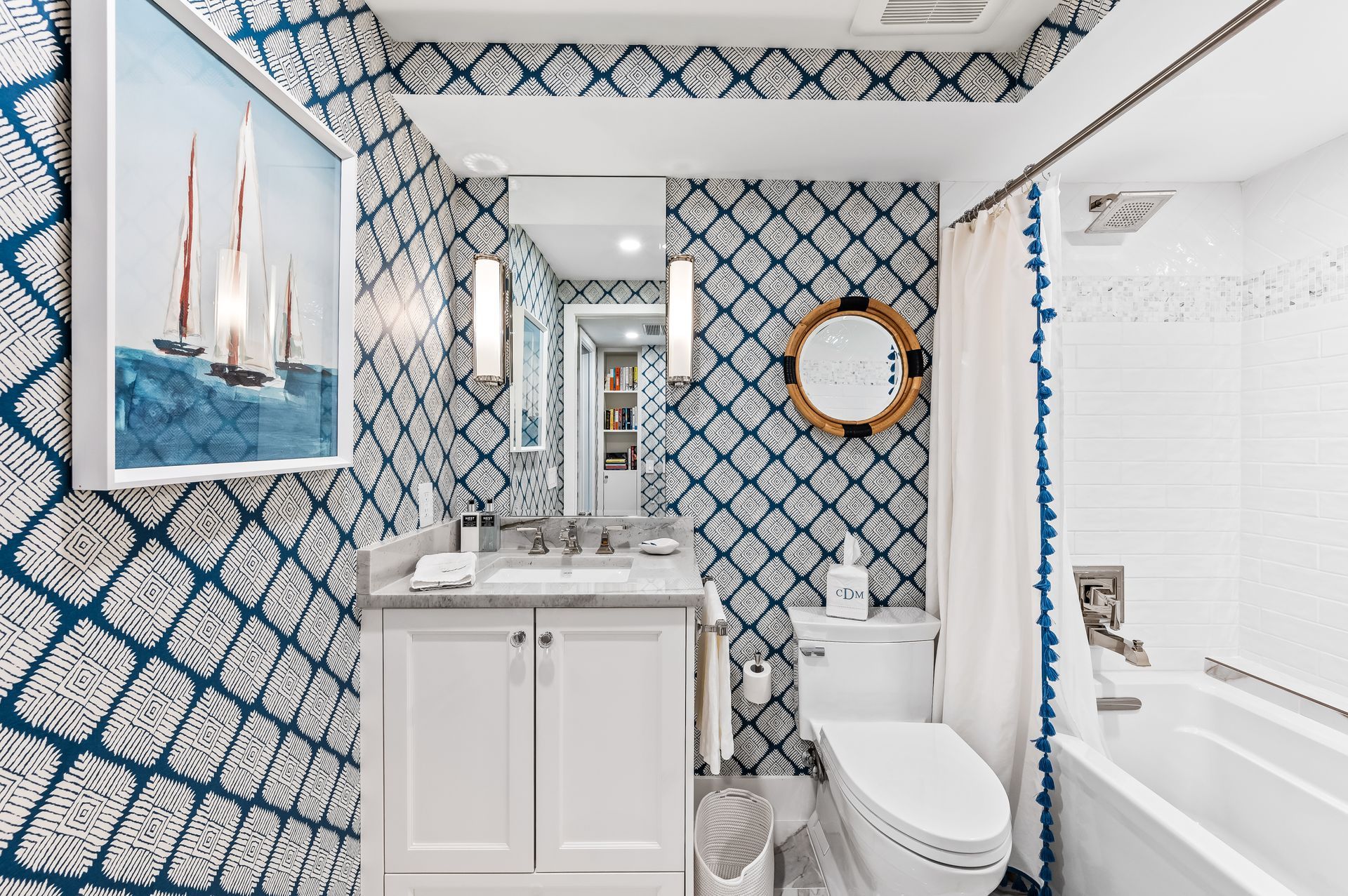 A bathroom with a toilet , sink , mirror and bathtub.